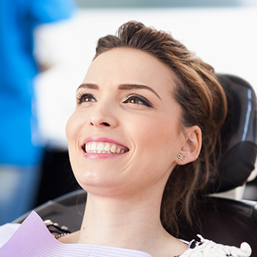 Woman smiling during oral cancer screening
