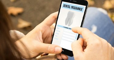 person filling out dental insurance forms on their phone  