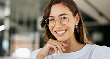 Woman with glasses smiling in office