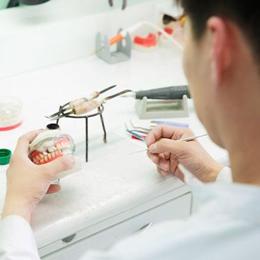 a technician working on constructing dentures