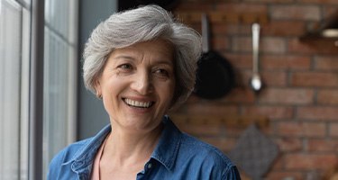 a woman smiling while at home