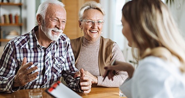 Senior couple talking to a receptionist