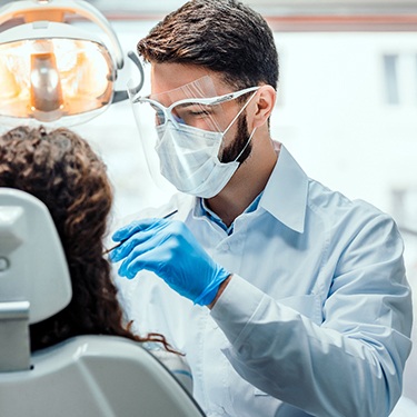 A dentist performing treatment on a patient