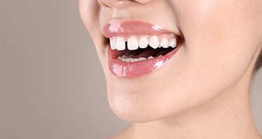 Nose-to-chin view of woman with gapped teeth smiling