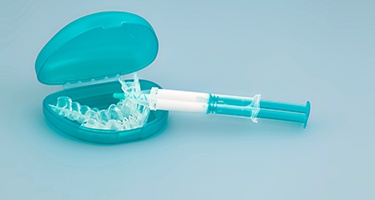 Teeth whitening gel with teal applicator and tray carrier