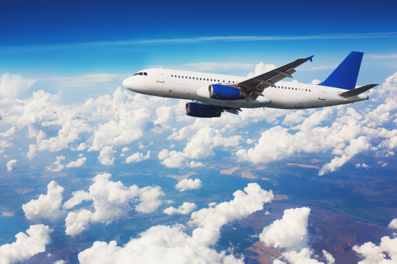 Plane flies over clouds