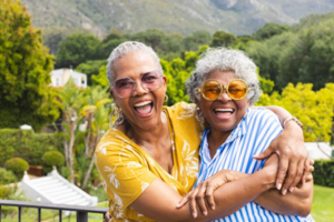 Two senior women laughing with their dentures and having a good time